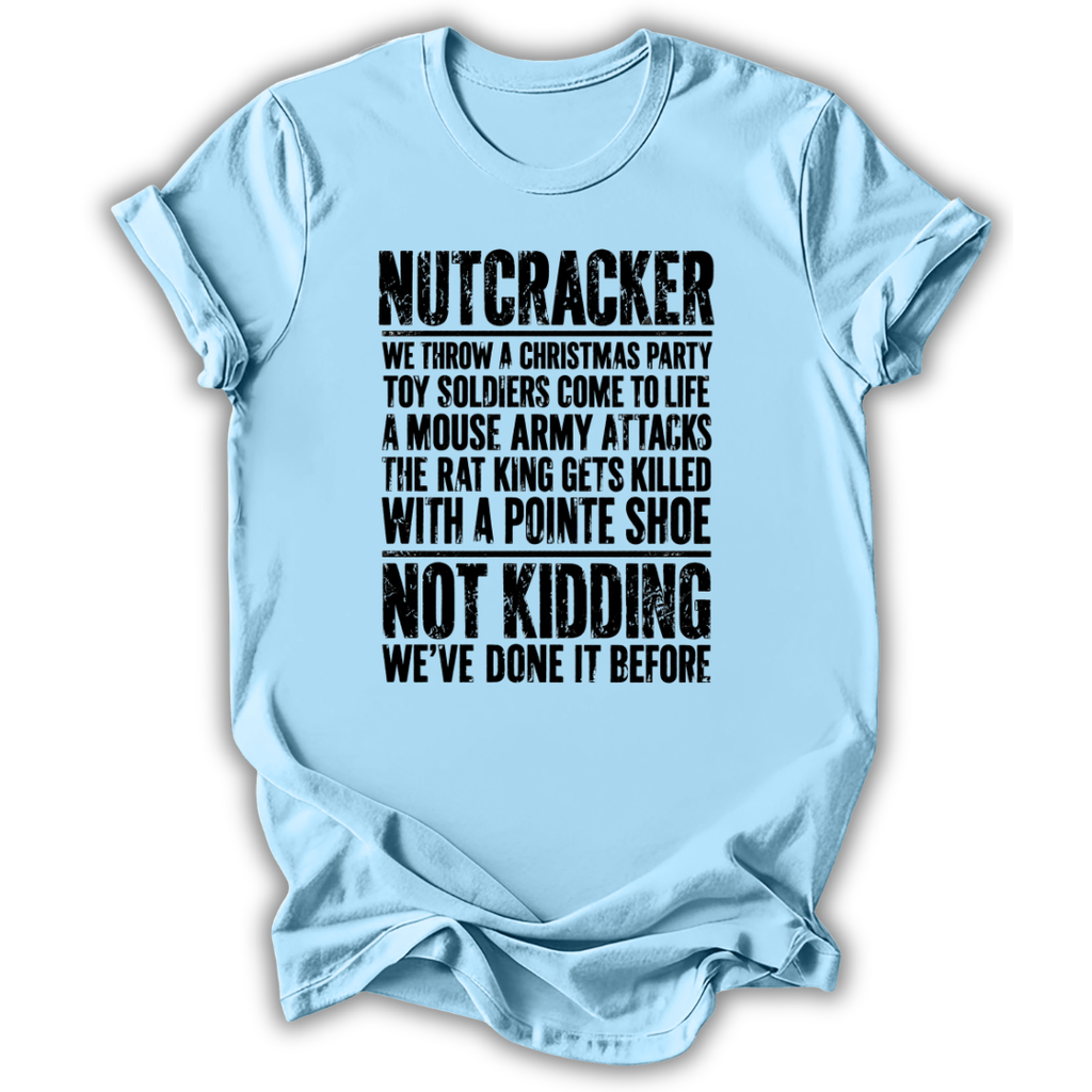 A light blue short-sleeve t-shirt with a humorous Christmas-themed text graphic printed in black on the front, displayed against a clean white background.
