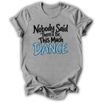 A heather gray short-sleeve t-shirt with a graphic text print reading 'Nobody Said There'd Be This Much DANCE' in black and light blue lettering, displayed on a white background.
