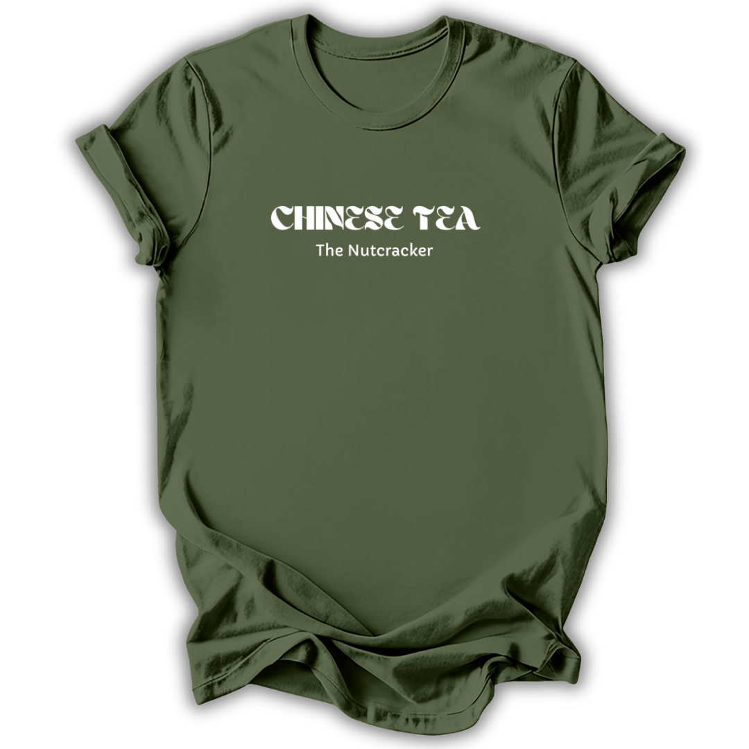An olive green short-sleeve t-shirt with white text reading 'CHINESE TEA' and 'The Nutcracker' printed on the chest, displayed against a clean white background.