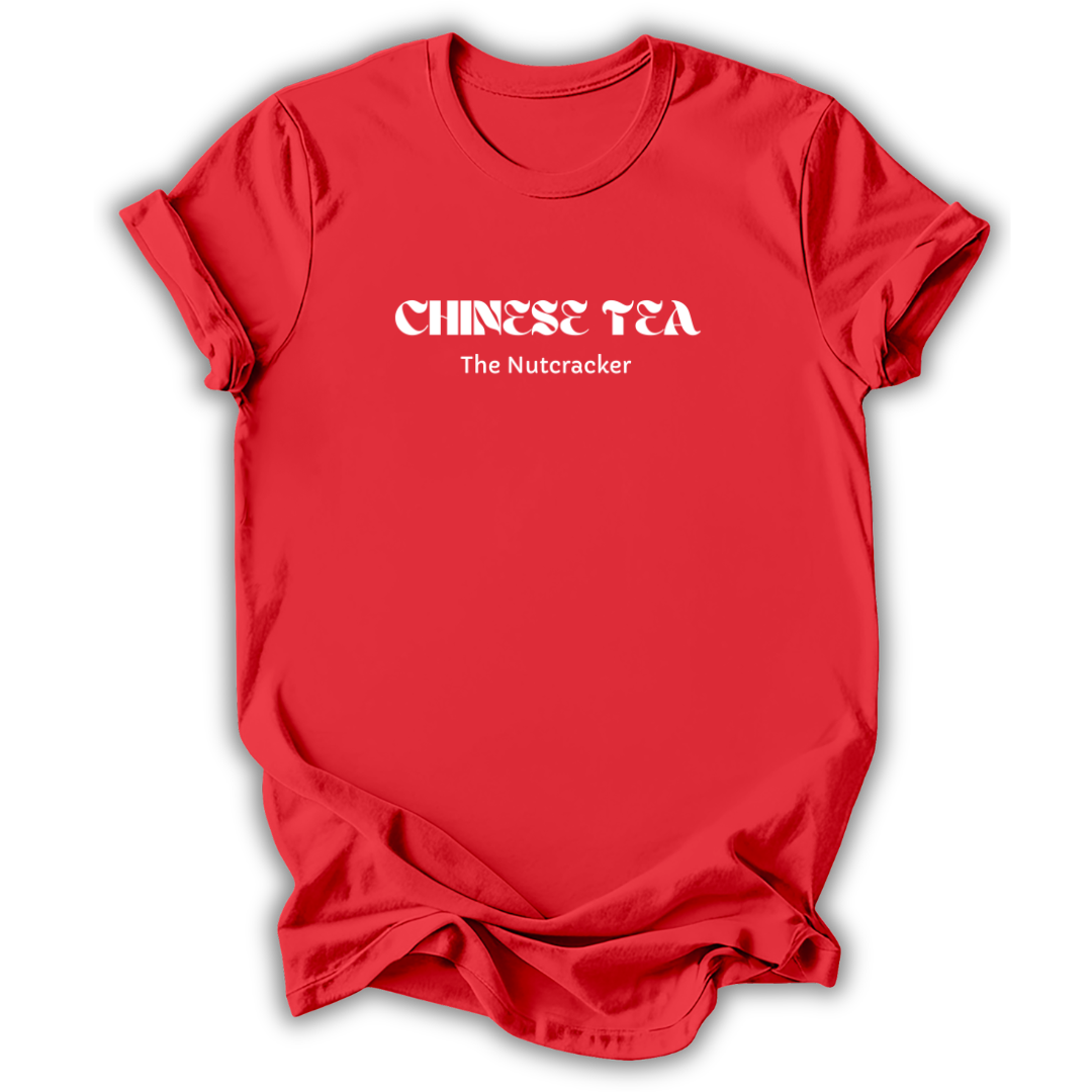 A red short-sleeve crewneck t-shirt with white text on the chest reading 'CHINESE TEA' in a stylized font and 'The Nutcracker' underneath, shown on a white background with a drop shadow.