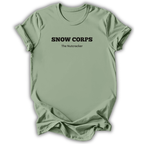 A sage green short-sleeve t-shirt with black printed text reading 'SNOW CORPS' and 'The Nutcracker' underneath, displayed flat against a white background.