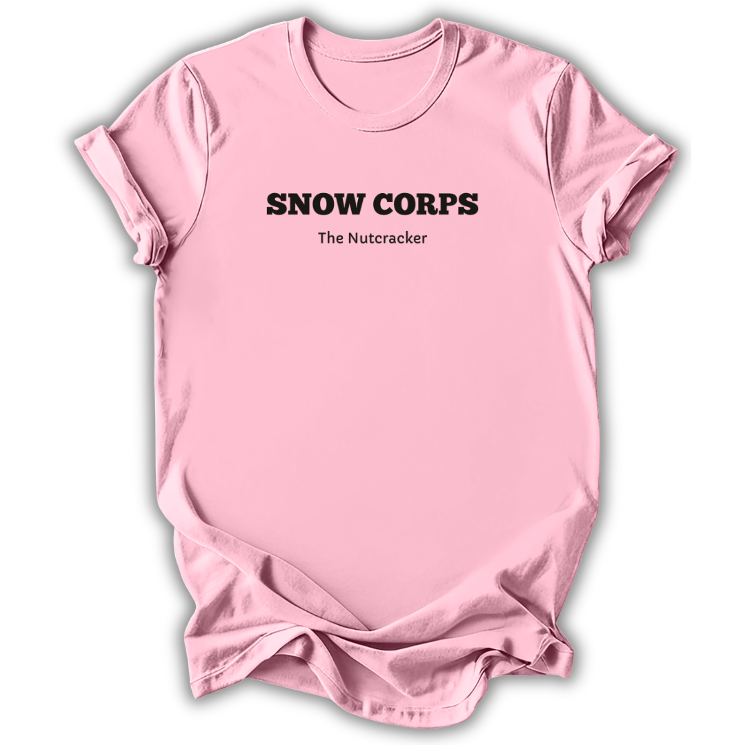 Pink short-sleeve t-shirt with black printed text reading 'SNOW CORPS' and 'The Nutcracker' underneath, displayed flat against a white background.