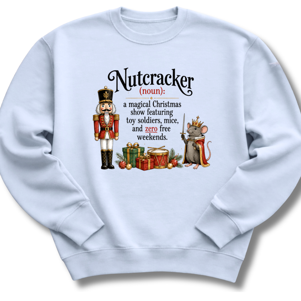 A light blue crewneck sweatshirt featuring a humorous graphic definition of 'Nutcracker' as a noun, illustrated with a nutcracker soldier and a crowned mouse with gifts.