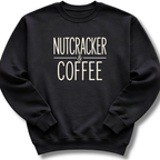 A black crewneck sweatshirt with the words 'NUTCRACKER & COFFEE' printed in a beige serif font on the chest, displayed against a plain white background.
