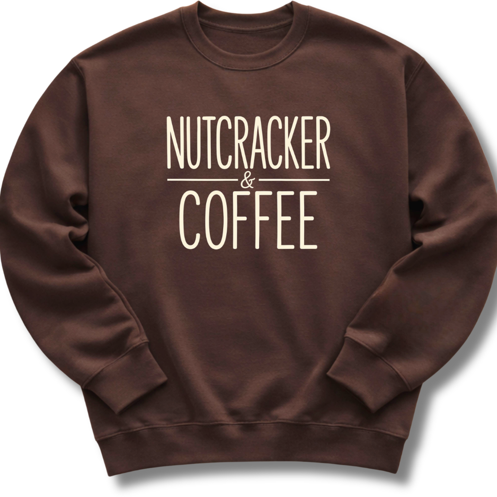 A dark brown crewneck sweatshirt with the words 'NUTCRACKER & COFFEE' printed in a cream-colored serif font on the chest, displayed against a clean white background.