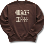 A dark brown crewneck sweatshirt with the words 'NUTCRACKER & COFFEE' printed in a cream-colored serif font on the chest, displayed against a clean white background.
