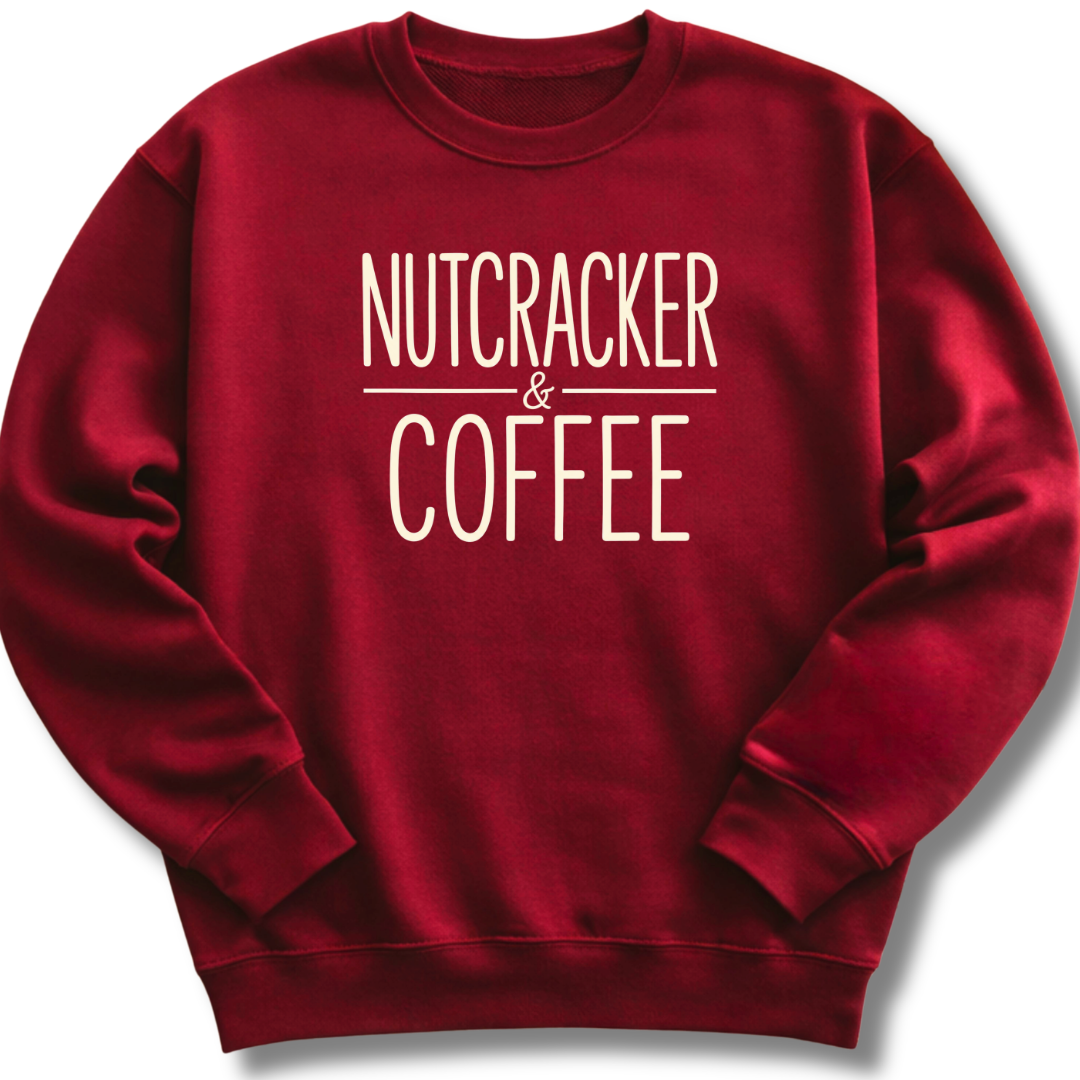 A dark red crewneck sweatshirt with the words 'NUTCRACKER & COFFEE' printed in a cream-colored serif font on the chest, displayed against a clean white background.