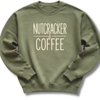 An olive green crewneck sweatshirt with the words 'NUTCRACKER & COFFEE' printed in a cream-colored serif font on the chest, displayed against a clean white background.
