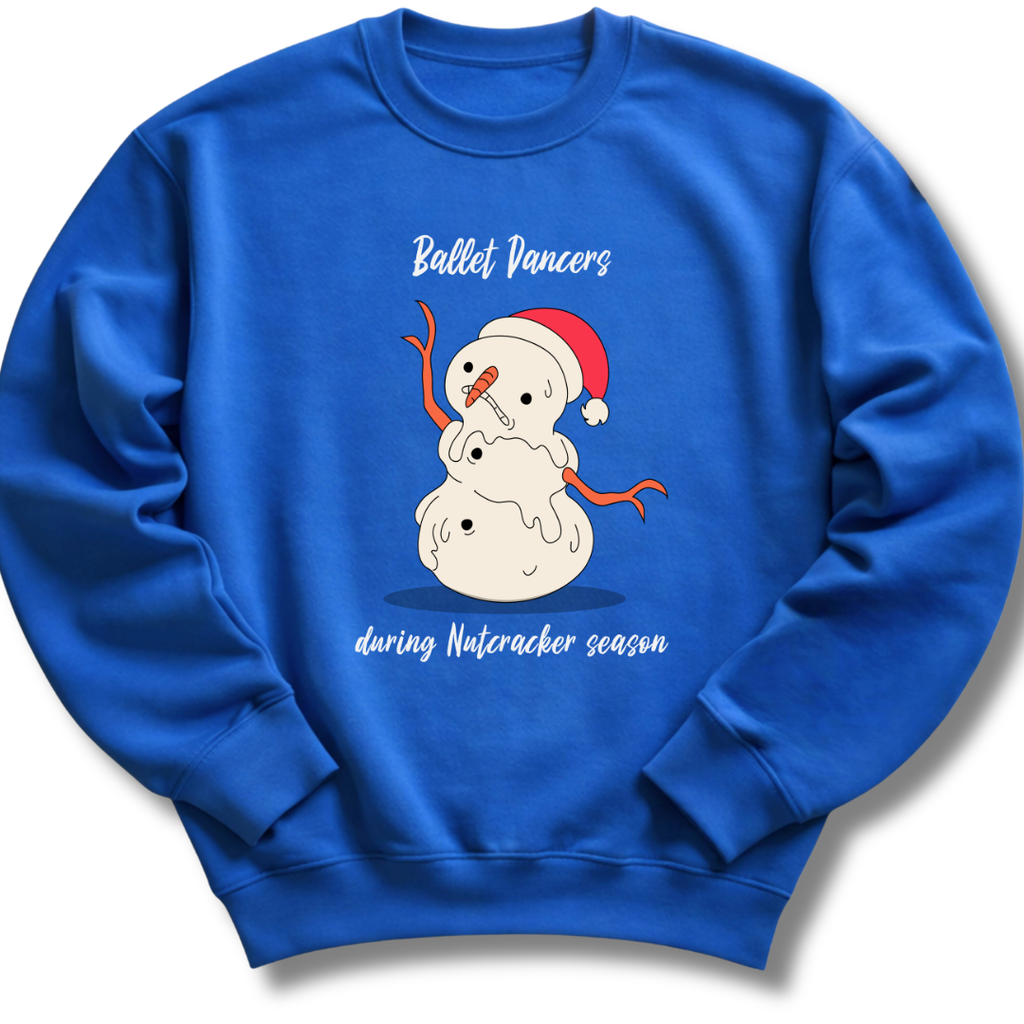 A royal blue crewneck sweatshirt featuring a cartoon snowman wearing a red Santa hat, with the text 'Ballet Vancers during Nutcracker season' printed on the front.