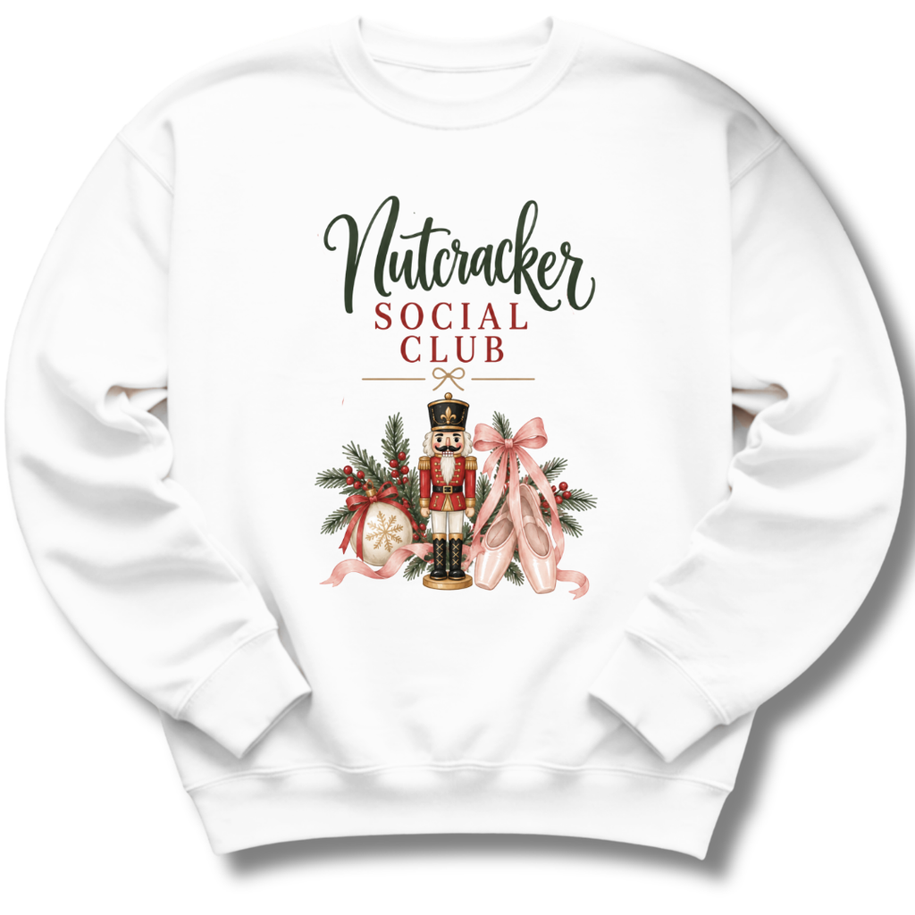 A white crewneck sweatshirt featuring a festive graphic print with the text 'Nutcracker Social Club' and an illustration of a nutcracker, pink ballet slippers, pine branches, and ornaments.