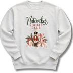 A light gray crewneck sweatshirt featuring a festive graphic print with the text 'Nutcracker Social Club' above an illustration of a nutcracker, pink ballet slippers, pine branches, and a red bow.
