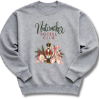 A heather gray crewneck sweatshirt featuring a festive graphic print on the front with the text 'Nutcracker Social Club' and an illustration of a nutcracker, pink ballet slippers, and holiday greenery.