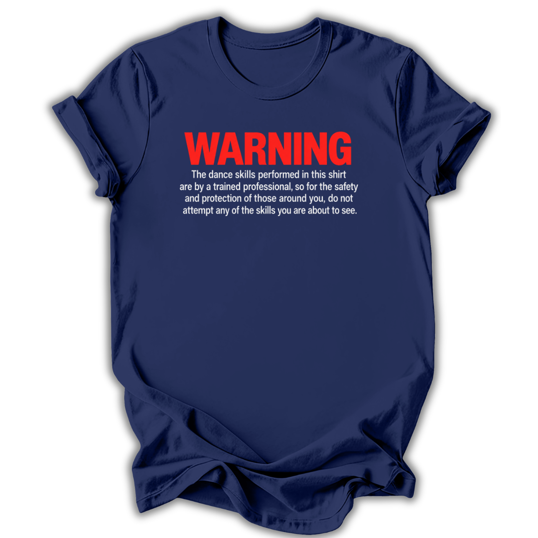 A navy blue short-sleeve t-shirt with a humorous warning printed on the chest. The text reads 'WARNING' in bold red letters, followed by white text explaining that the dance skills shown are performed by a trained professional for safety.