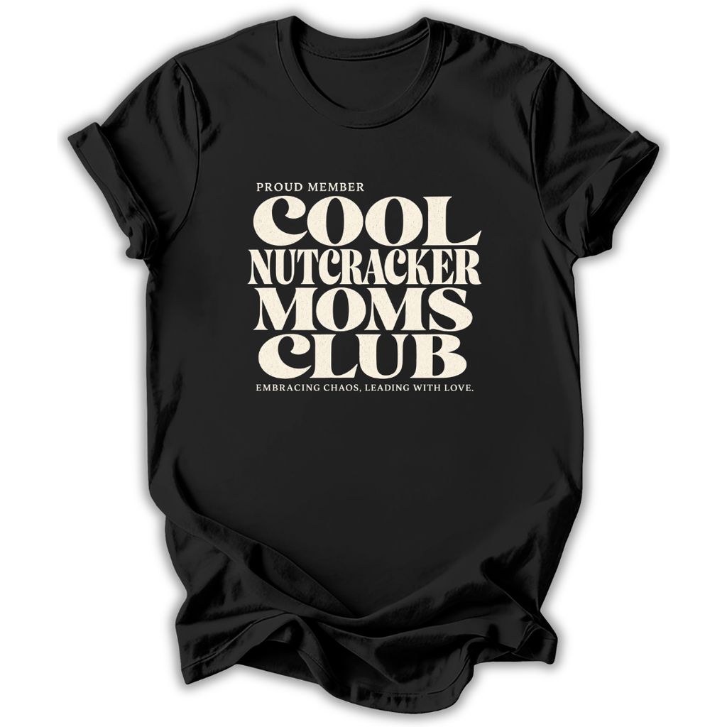 Black short-sleeve crewneck t-shirt with a cream-colored retro graphic that reads 'PROUD MEMBER COOL NUTCRACKER MOMS CLUB' and 'EMBRACING CHANGE, LEADING WITH LOVE.'.