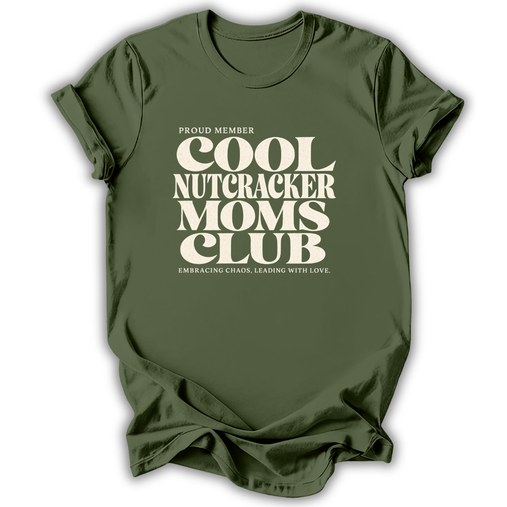 Green short-sleeve crewneck t-shirt with a cream-colored retro graphic that reads 'PROUD MEMBER COOL NUTCRACKER MOMS CLUB' and 'EMBRACING CHANGE, LEADING WITH LOVE.'.