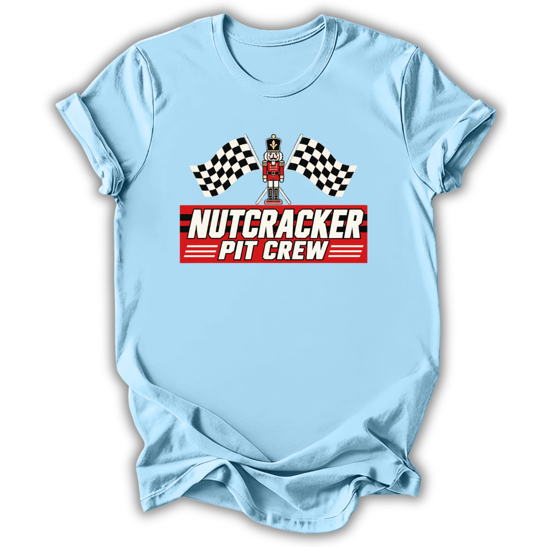 Blue short-sleeve t-shirt with a 'Nutcracker Pit Crew' graphic on the chest, featuring a race flag checkered pattern and a pit crew character, displayed on a clean white background.