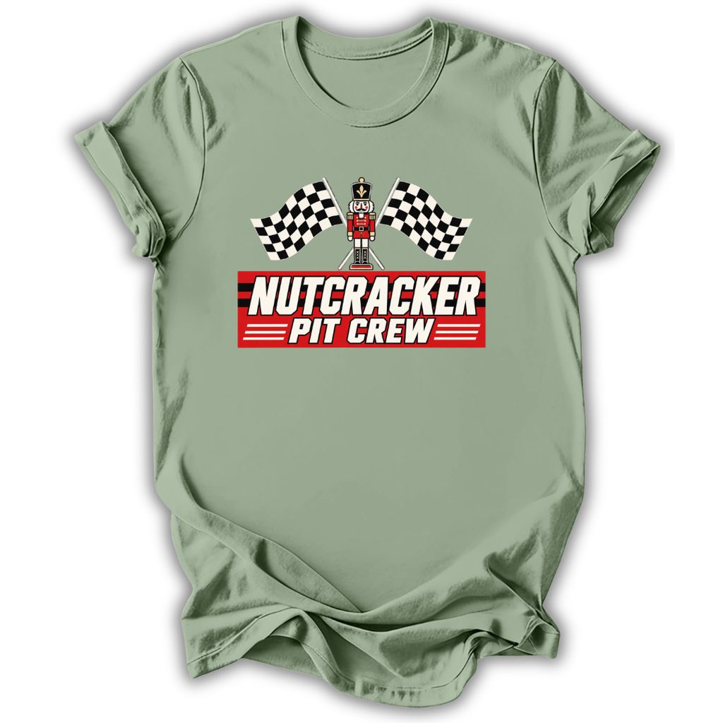 Sage short-sleeve t-shirt with a 'Nutcracker Pit Crew' graphic on the chest, featuring a race flag checkered pattern and a pit crew character, displayed on a clean white background.