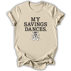 A beige short-sleeve t-shirt with the text 'MY SAVINGS DANCES.' printed in black, accompanied by a graphic of white ballet pointe shoes, shown on a white background.