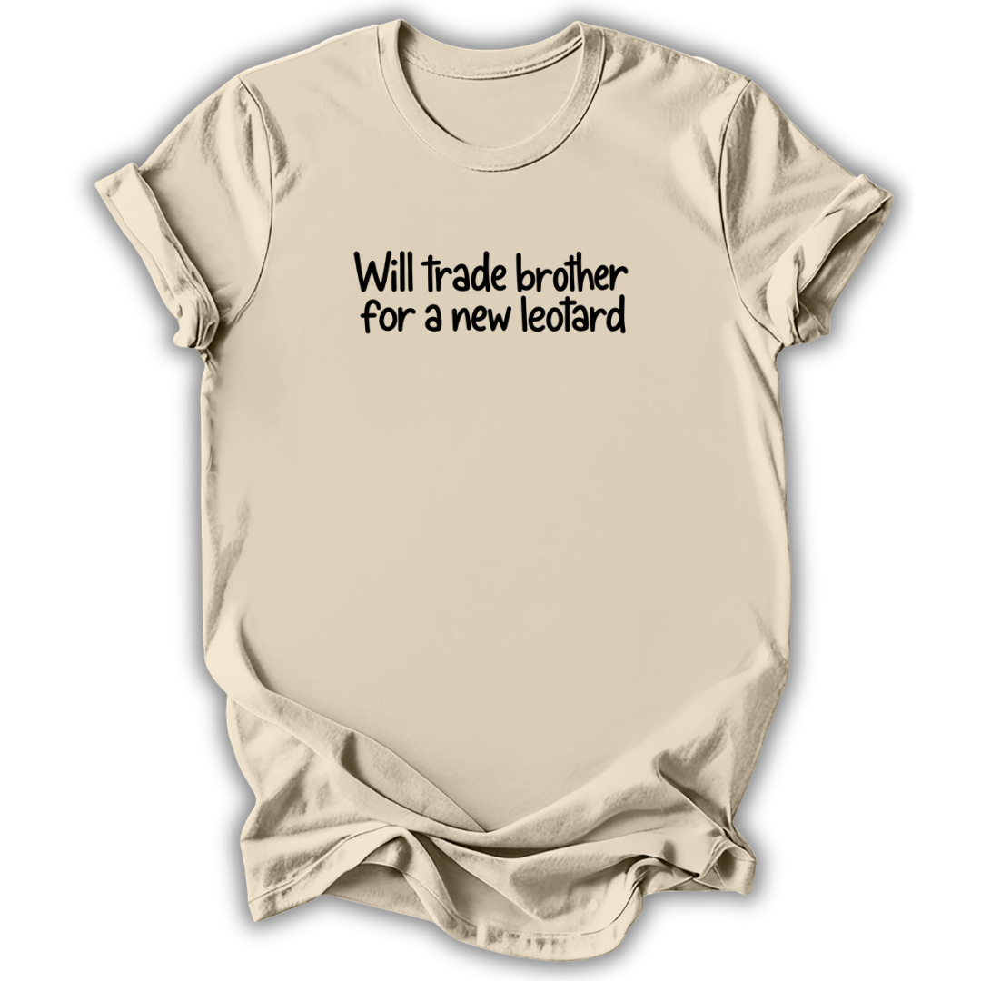 A light beige crewneck t-shirt with the phrase 'Will trade brother for a new leotard' printed in black text across the chest, displayed against a clean white background.