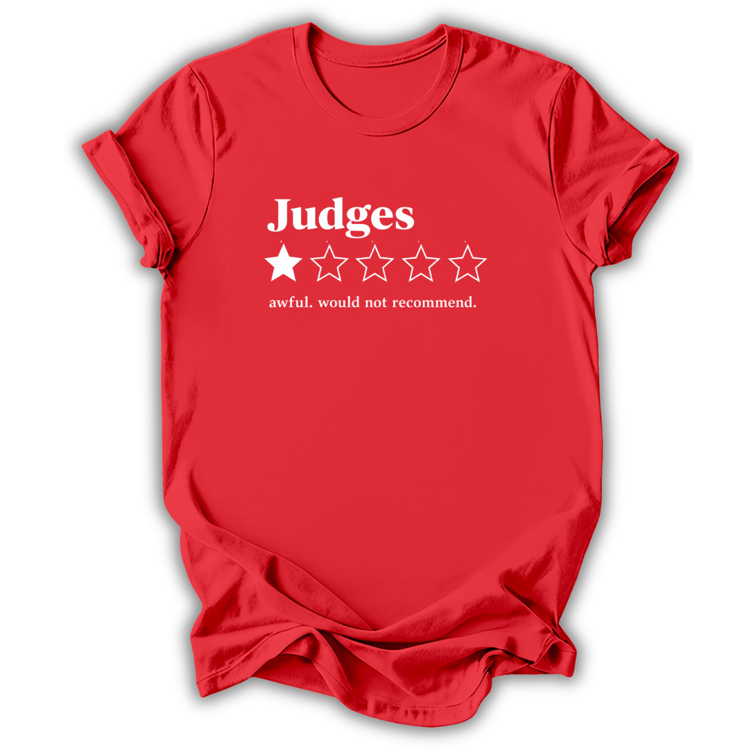 A red short-sleeve t-shirt with a white graphic print on the front reading 'Judges' above a one-out-of-five star rating system, with the phrase 'awful. would not recommend.