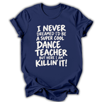 A navy blue short-sleeve t-shirt with a white graphic text print on the front that reads 'I NEVER DREAMED I'D BE A SUPER COOL DANCE TEACHER BUT HERE I AM KILLIN' IT!' on a white background.