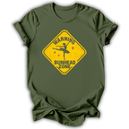 An olive green short-sleeve t-shirt with a yellow diamond-shaped road sign graphic on the chest that reads 'WARNING BUNHEAD ZONE' with a silhouette of a ballerina.