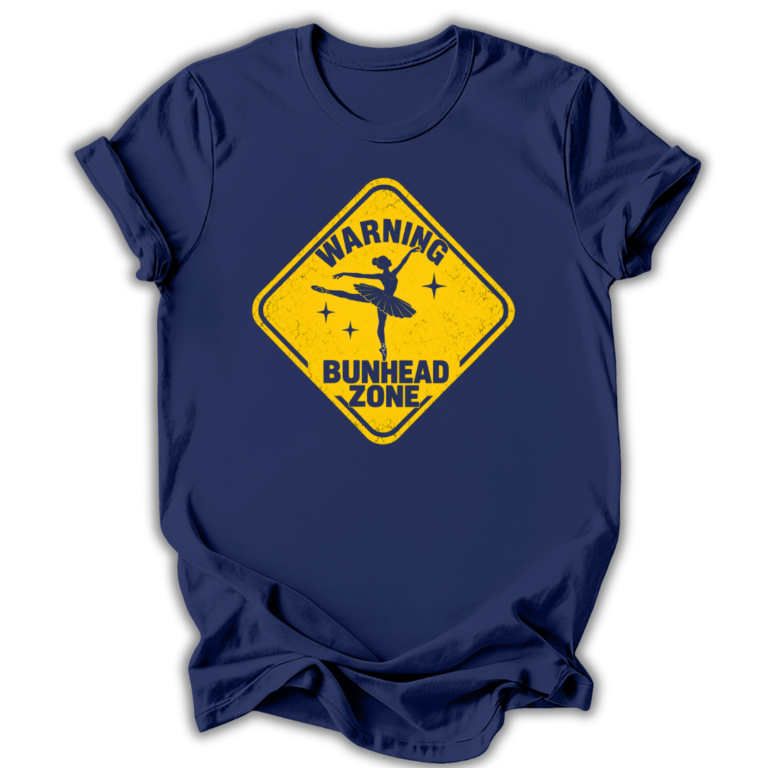 A navy blue short-sleeve t-shirt with a yellow diamond-shaped warning sign graphic on the chest that reads 'WARNING BUNHEAD ZONE' with a silhouette of a ballerina.