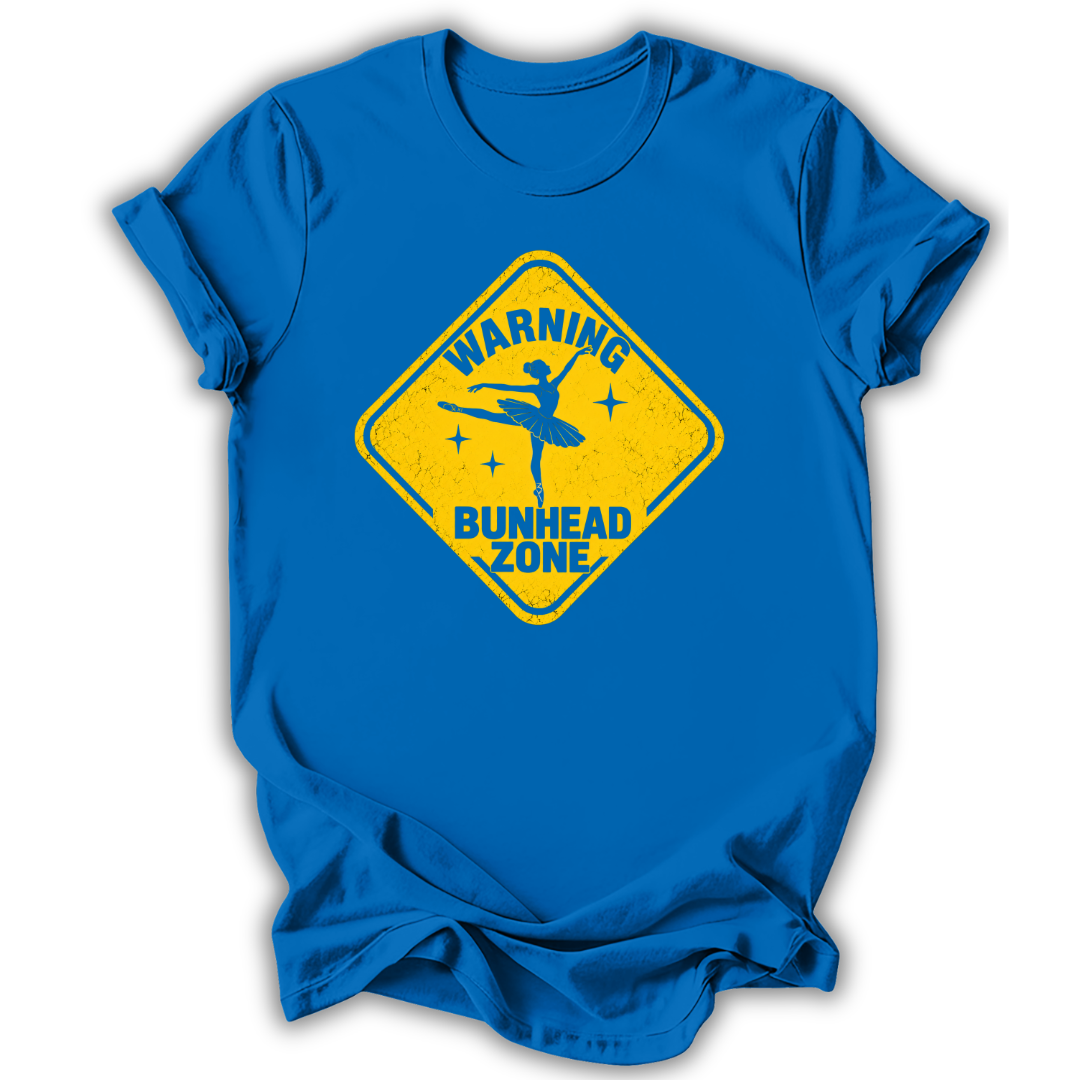 A royal blue short-sleeve t-shirt with a yellow diamond-shaped road sign graphic on the chest that reads 'WARNING BUNHEAD ZONE' with a silhouette of a ballerina.