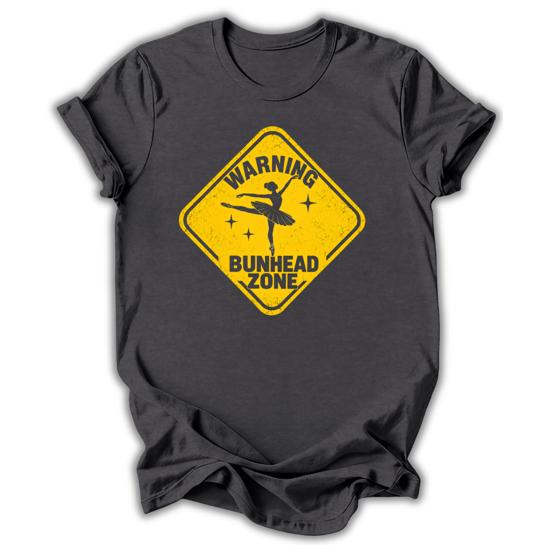 A dark charcoal gray t-shirt with a yellow diamond-shaped warning sign graphic on the front, featuring a silhouette of a ballerina and the text 'WARNING BUNHEAD ZONE'.