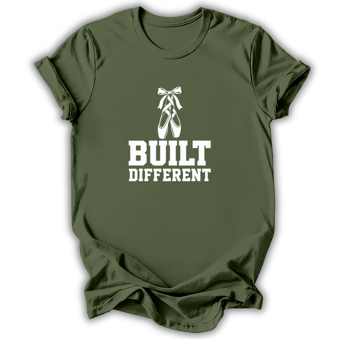An olive green short-sleeve t-shirt with a white graphic print featuring a ballet pointe shoe and the text 'BUILT DIFFERENT'.