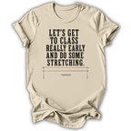 A beige graphic t-shirt featuring a black printed quote from Hippocrates: 'LET'S GET TO CLASS REALLY EARLY AND DO SOME STRETCHING.' above a simple barbell illustration, shown on a white background.