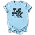 A light blue short-sleeve t-shirt with a black printed quote on the front that reads 'LET'S GET TO CLASS REALLY EARLY AND DO SOME STRETCHING.' Below the quote is a small illustration of a stretching bar and the attribution 'PippiLauten.