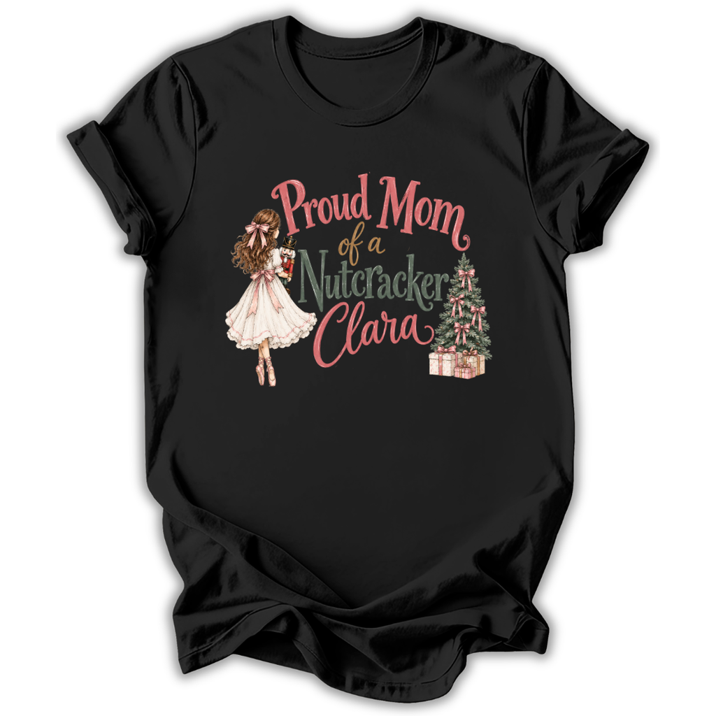 A black short-sleeve t-shirt with a graphic print on the front. The graphic features the text 'Proud Mom of a Nutcracker Clara' in pink and green lettering, accompanied by an illustration of a girl in a white dress and a decorated Christmas tree with wrapped gifts.