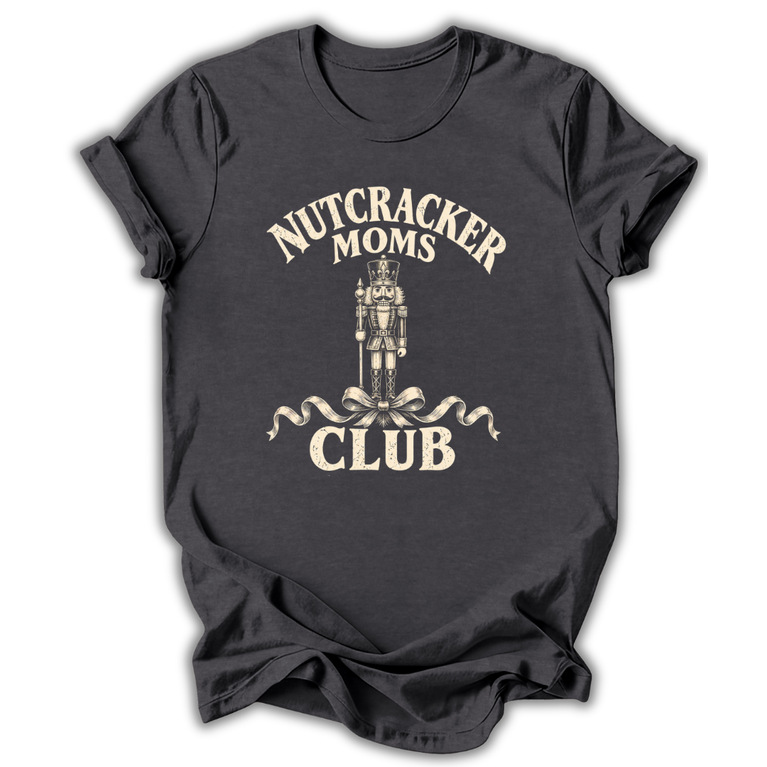 A dark charcoal gray t-shirt with a vintage-style cream graphic that reads 'NUTCRACKER MOMS CLUB' surrounding an illustration of a nutcracker and ribbon bow.