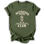 An olive green short-sleeve t-shirt with a distressed cream-colored graphic that reads 'NUTCRACKER MOMS CLUB' around a nutcracker illustration, shown on a plain white background.
