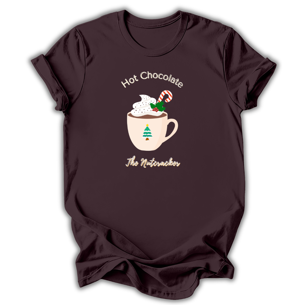 A black short-sleeve t-shirt with a graphic of a nutcracker character in a teal and peach dress, accompanied by the text 'NUTCRACKER IS MY FAVORITE SEASON' in light blue-green lettering.