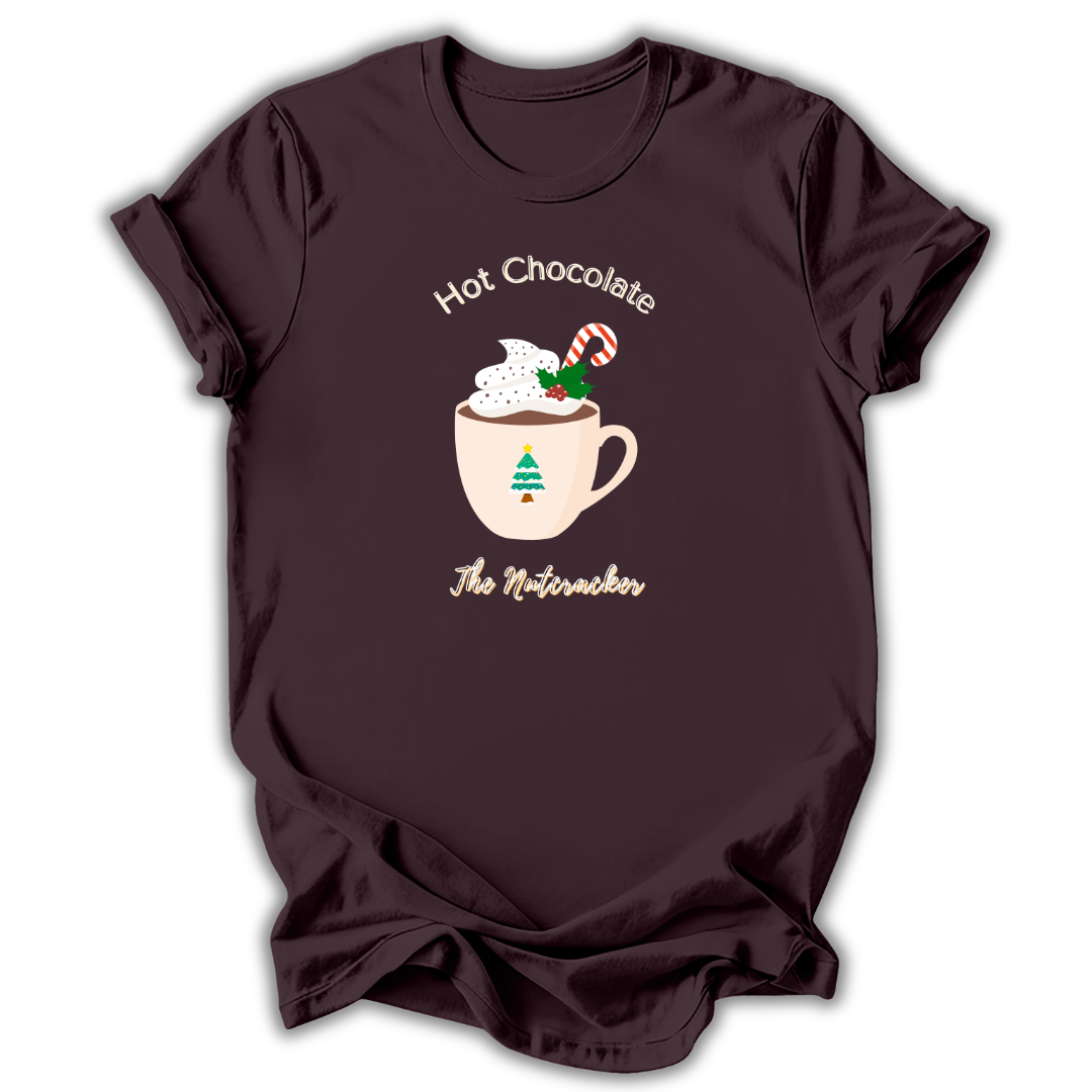 A black short-sleeve t-shirt with a graphic of a nutcracker character in a teal and peach dress, accompanied by the text 'NUTCRACKER IS MY FAVORITE SEASON' in light blue-green lettering.