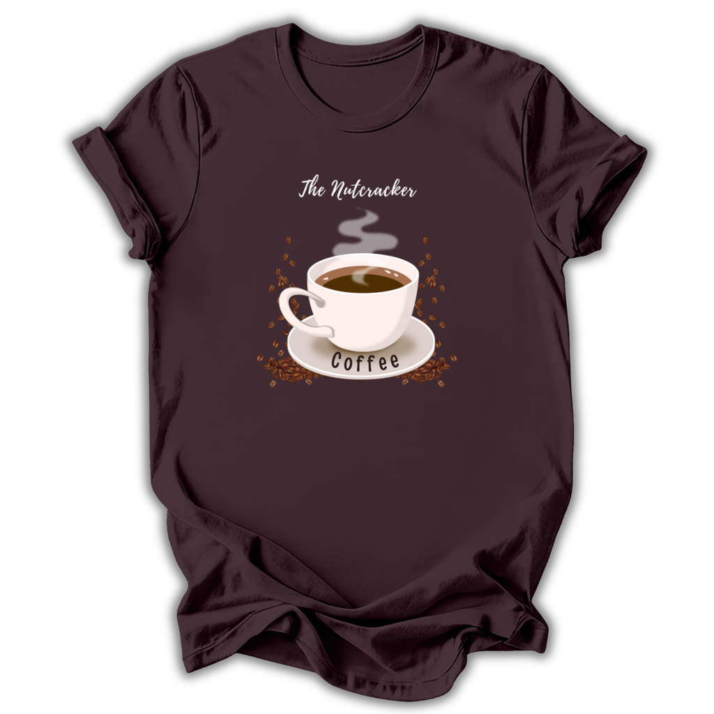 A dark brown short-sleeve t-shirt with a graphic of a white coffee cup on a saucer, surrounded by coffee beans and steam, with the text 'The Nutcracker' above and 'Coffee' below.