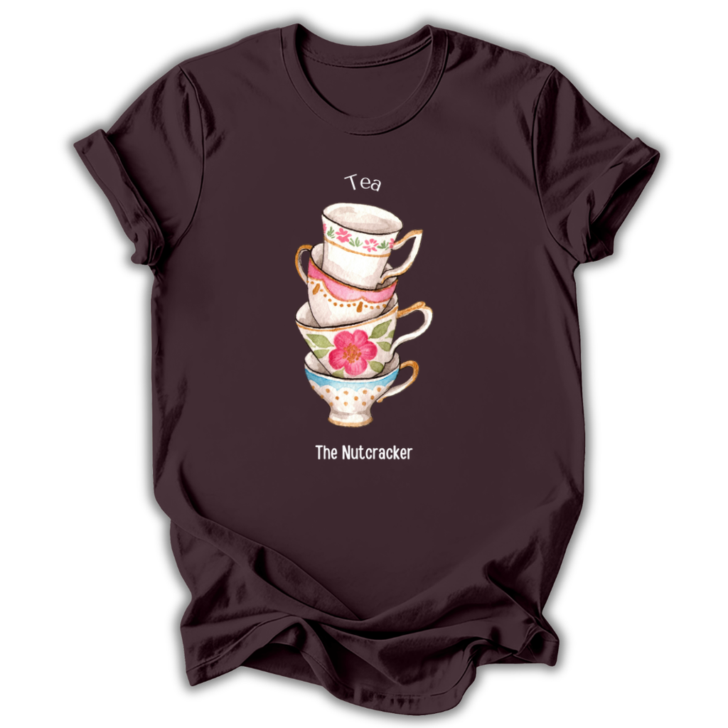 A dark brown short-sleeve t-shirt with a graphic of a stack of four colorful teacups and the text 'Tea' and 'The Nutcracker' printed on the front, shown against a plain white background.