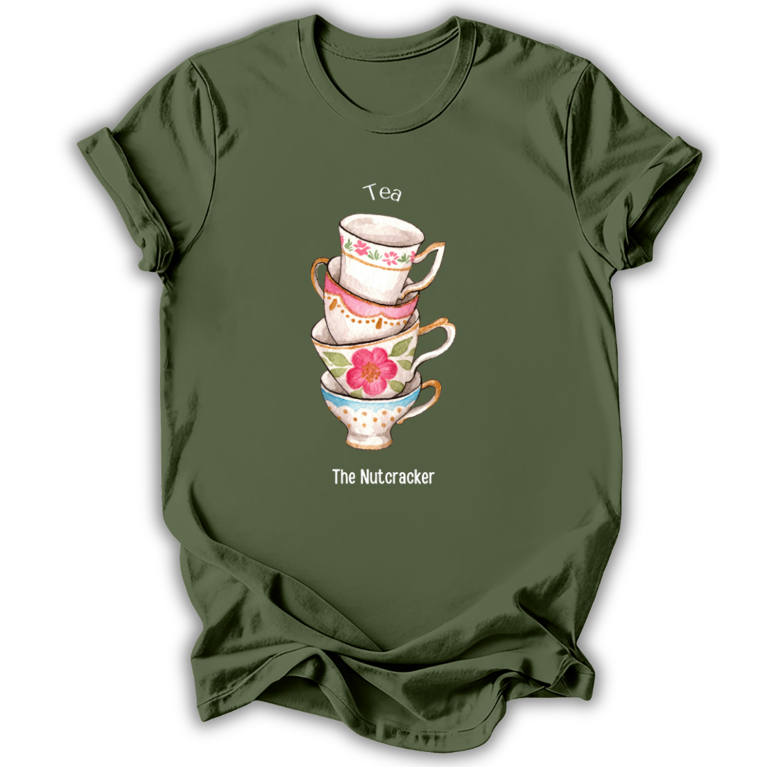 An olive green short-sleeve t-shirt with a graphic of a stack of four teacups featuring floral patterns and the text 'Tea' above and 'The Nutcracker' below, displayed on a clean white background.