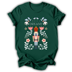 A dark charcoal gray t-shirt with a graphic print of a nutcracker surrounded by flowers and the text 'IN MY NUTCRACKER MOM ERA'.
