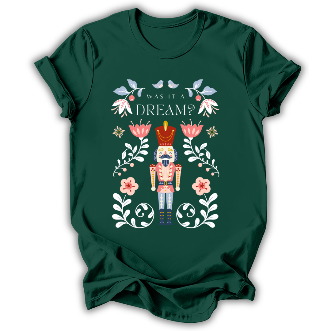 A dark charcoal gray t-shirt with a graphic print of a nutcracker surrounded by flowers and the text 'IN MY NUTCRACKER MOM ERA'.