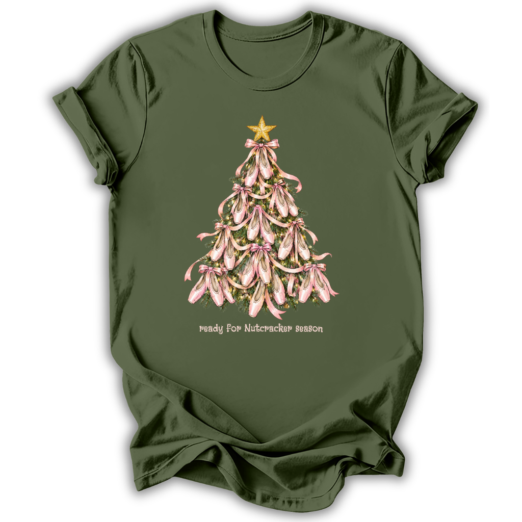 An olive green short-sleeve t-shirt with a graphic of a Christmas tree made of pink orchids with a gold star, and the text 'ready for Nutcracker season' printed below.