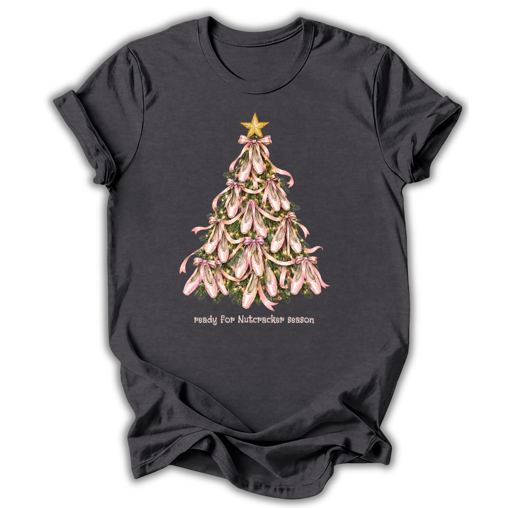 A dark charcoal gray t-shirt with a graphic of a Christmas tree made of pink orchids, topped with a gold star and the text 'ready for Nutcracker season' printed below.