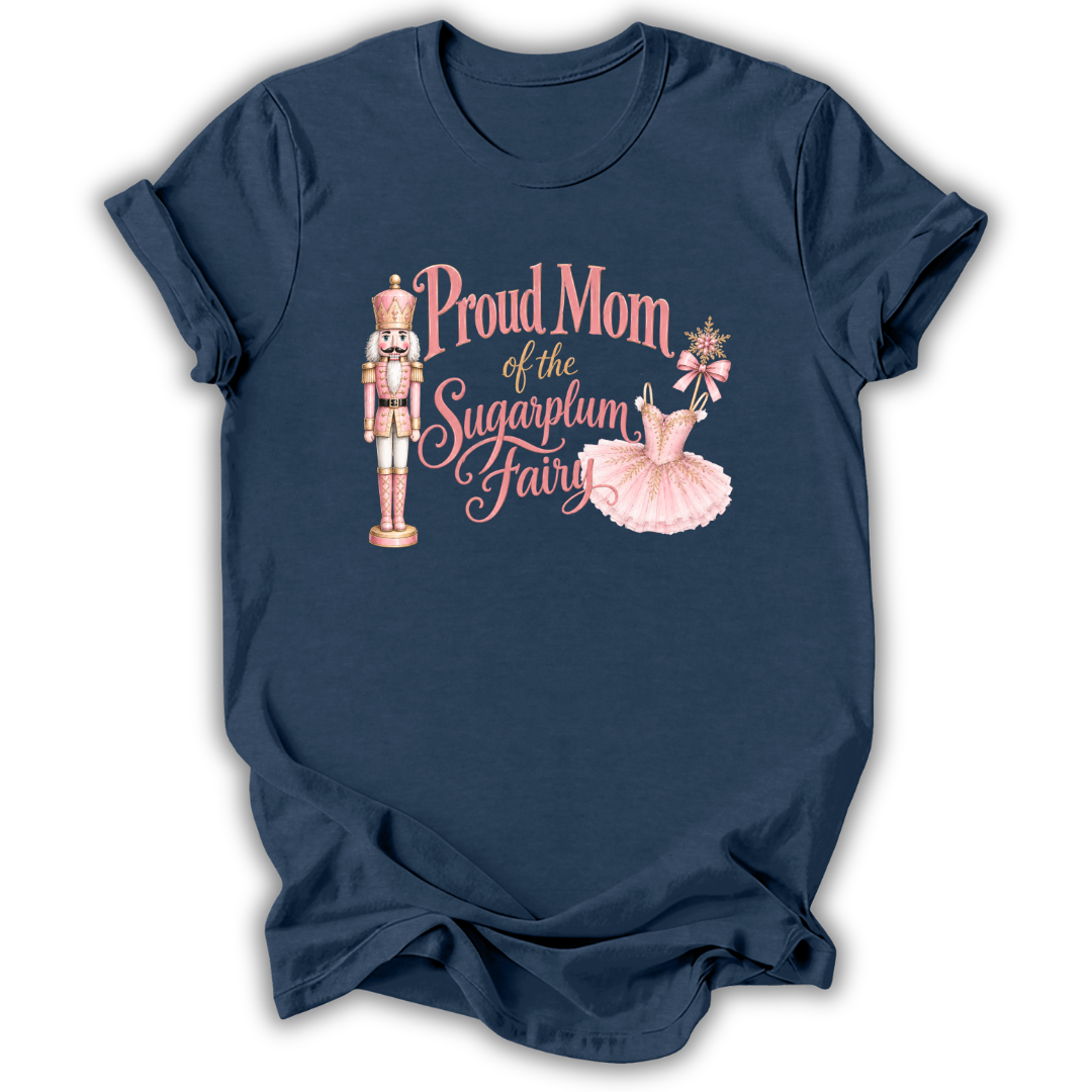 A navy blue short-sleeve t-shirt with a graphic print on the front. The graphic features a pink and gold nutcracker, a pink ballerina, and the text 'Proud Grandma of the Sugarplum Fairy' in pink and gold script.