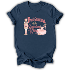 A navy blue short-sleeve t-shirt with a graphic print on the front. The graphic features a pink and gold nutcracker, a pink ballerina, and the text 'Proud Grandma of the Sugarplum Fairy' in pink and gold script.