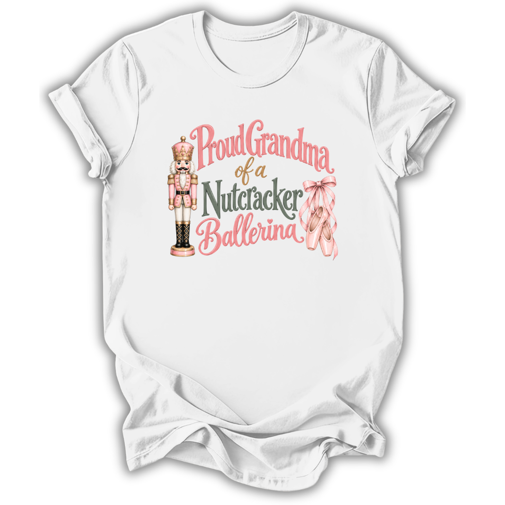 A white short-sleeve crewneck t-shirt with a graphic print on the front. The graphic features a pink and gold nutcracker, pink ballet slippers, and the text 'Proud Grandma of a Nutcracker Ballerina' in pink and gold lettering.