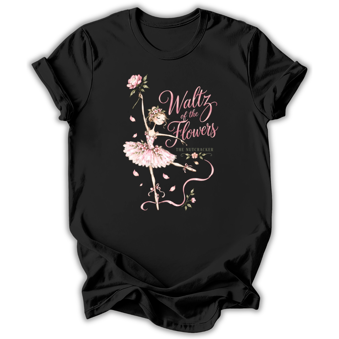 A black short-sleeve t-shirt with a graphic print of a ballerina in a pink tutu holding a pink flower, next to the text 'Waltz of the Flowers' and 'The Sophomore' in a cursive font, shown on a plain white background.