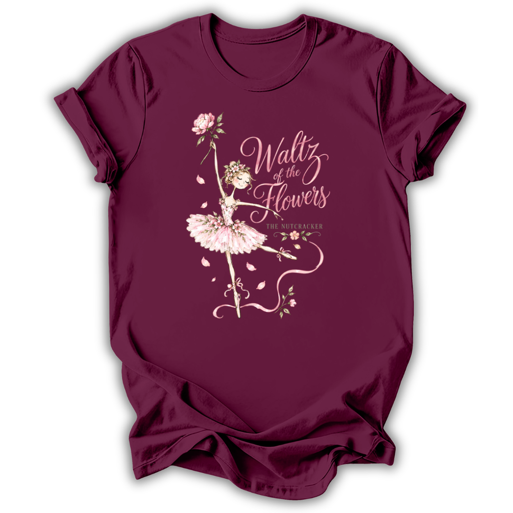 A maroon short-sleeve t-shirt with a graphic print of a ballerina in a pink tutu and rose, featuring the text 'Waltz of the Flowers' and 'The Night Before' on a white background.