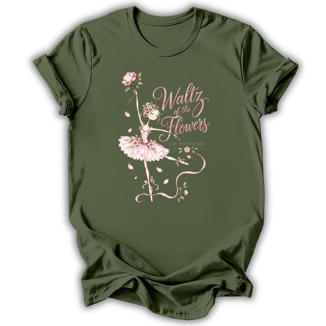 An olive green short-sleeve t-shirt with a pink graphic of a ballerina and the text 'Waltz of the Flowers' on the front, displayed against a clean white background.